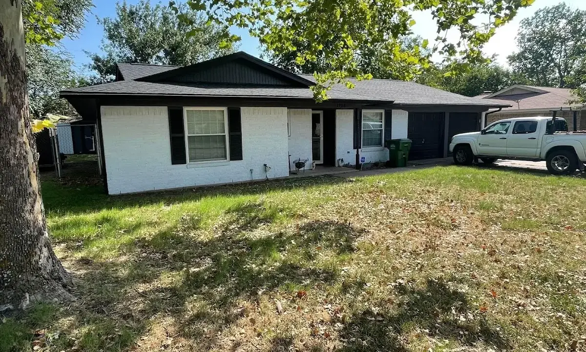 Professional roofing crew working on a residential roof in Carmel